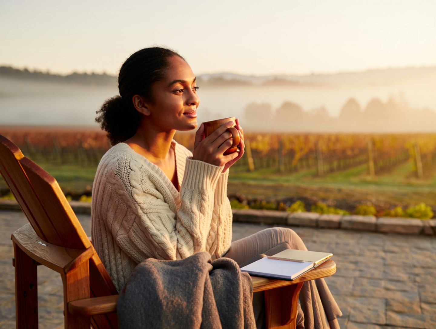 Healthcare professional resting on a vineyard terrace in Napa Valley during a quiet morning, symbolizing recovery, care, and emotional replenishment.