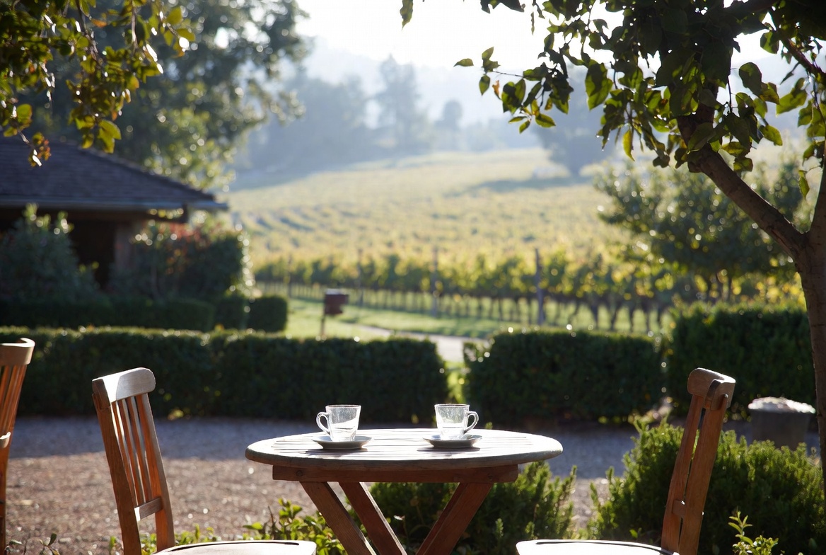 Outdoor table with coffee cups in Napa Valley during a quiet morning, symbolizing rest, presence, and unhurried travel.