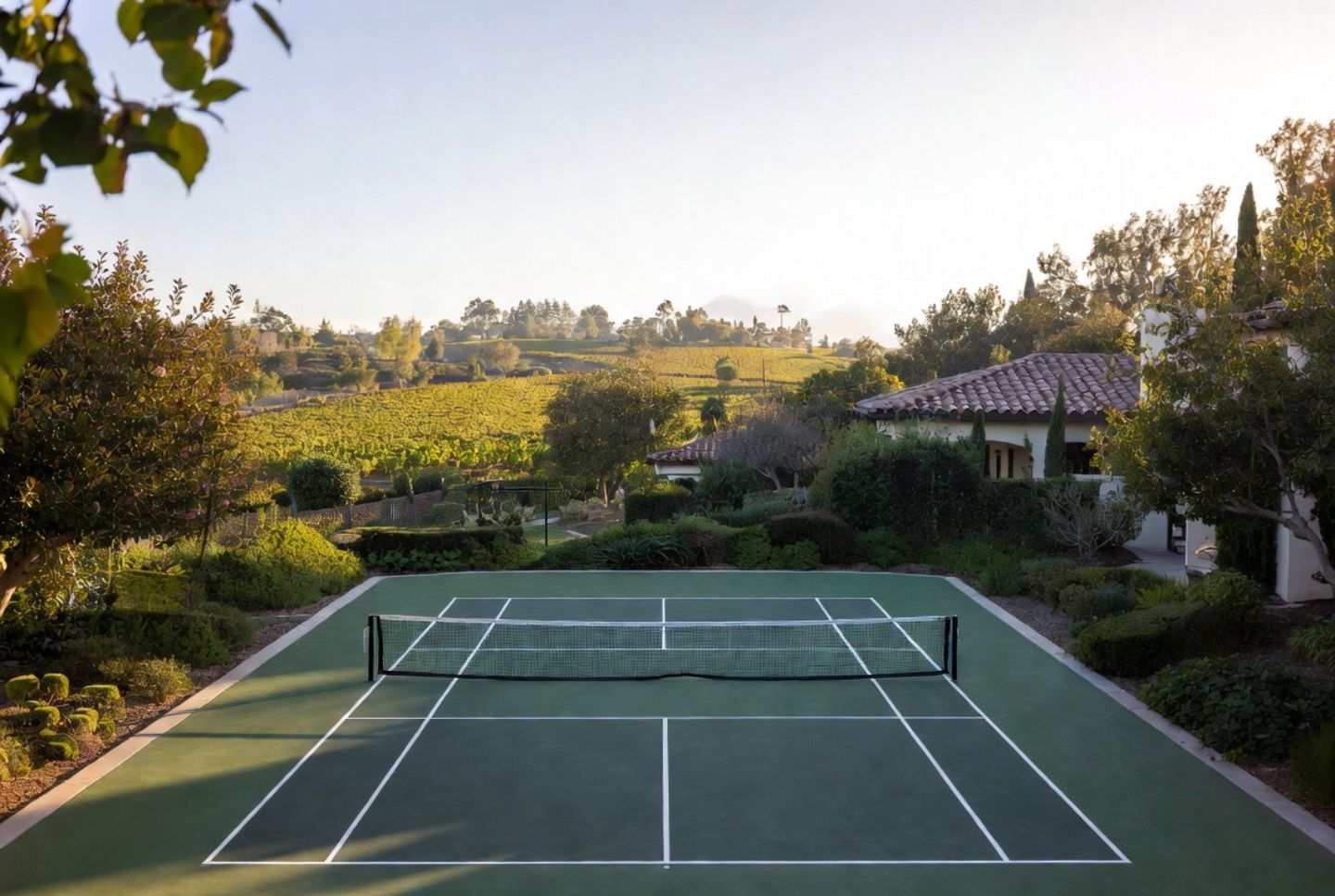 Outdoor pickleball court at a resort in Yountville Napa Valley with vineyard views in early morning light.
